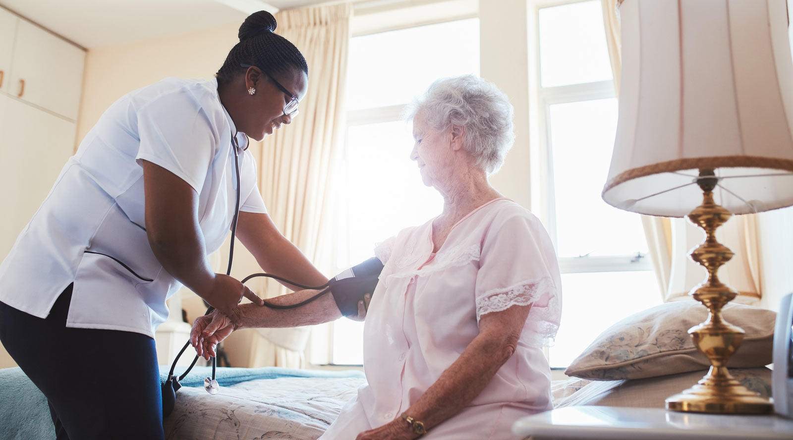 Home care nurse providing support to a senior patient