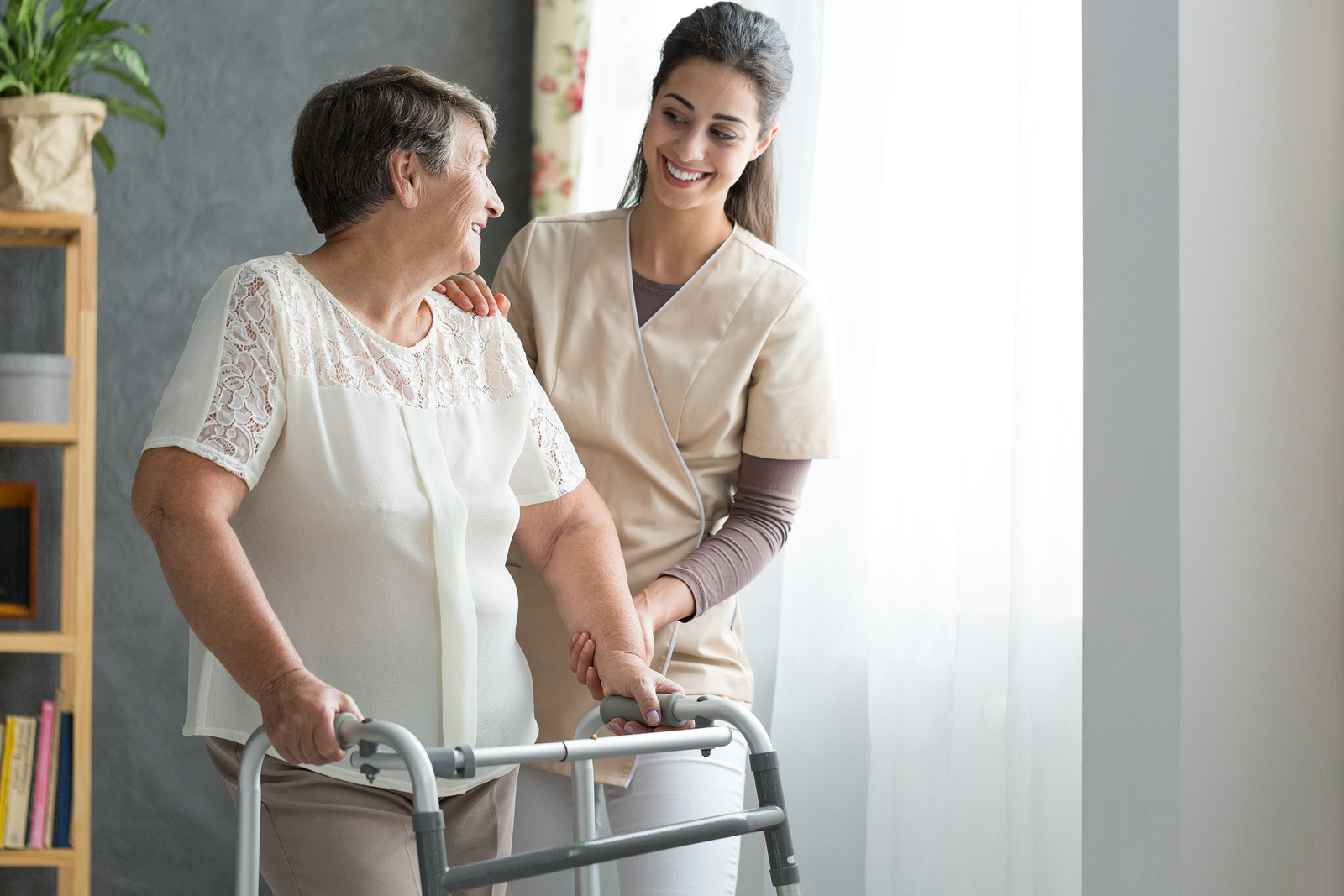 Caregiver assisting elderly client at home